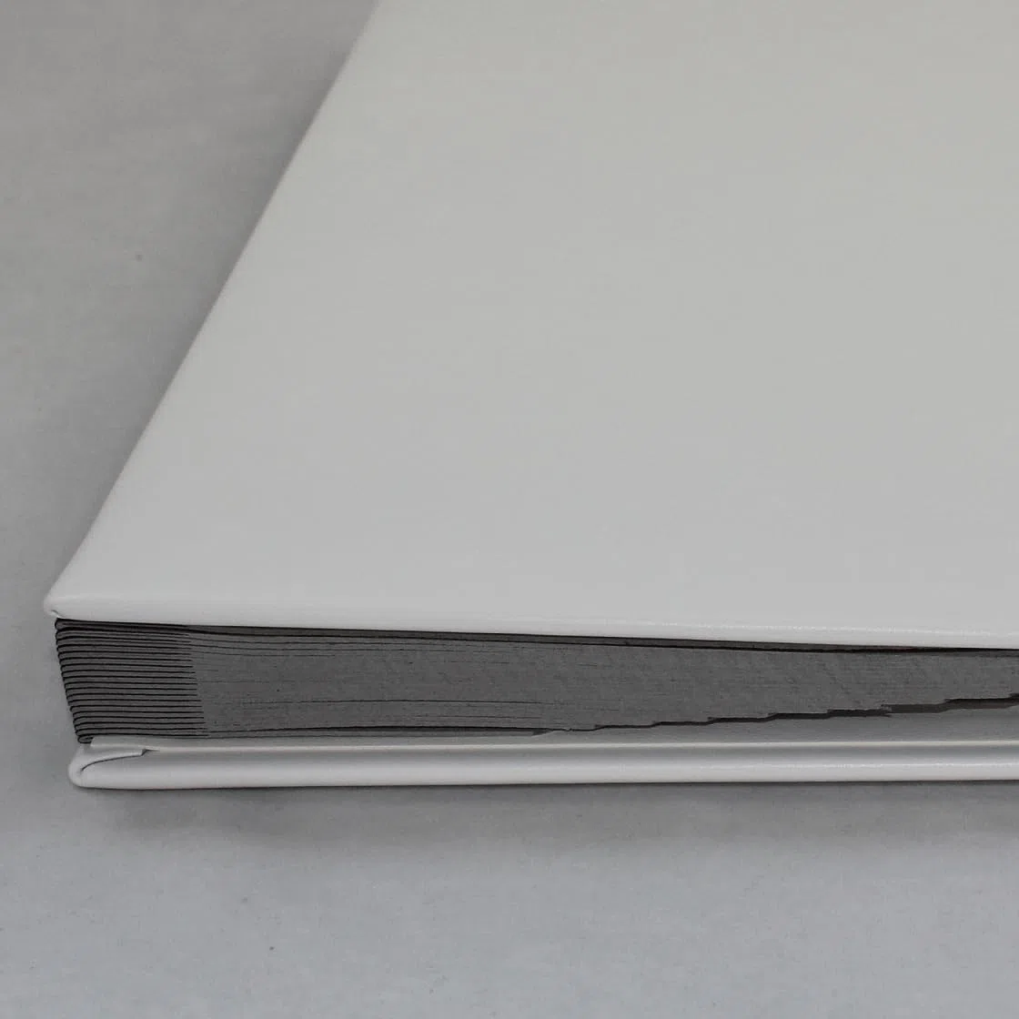 Unterschriftenmappe aus glattem Vollrindleder in Weiß, Softcover, dehnbarer Rücken, 20 Register-Trennblätter aus stabiler grauer Kartonage, Aufnahme von DIN A4, Prägungen auf Anfrage